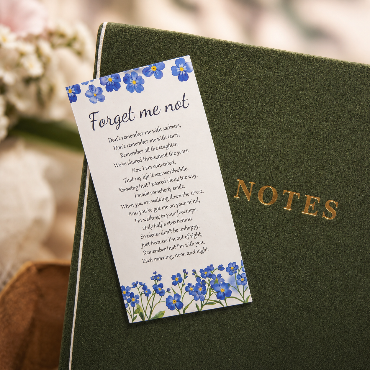 &lsquo;Forget me not&rsquo; inspirational card resting on NOTES journal